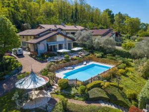 an aerial view of a house with a swimming pool at Green Hill Property in Besozzo
