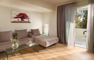 a living room with a couch and a glass table at Blazer Suites Hotel in Athens +34 photos