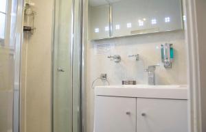 a bathroom with a sink and a shower at Apartment 4 Pheonix Flats in Portree
