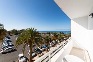a view of a parking lot with palm trees and cars at 2 min Walk to Beach - Private Terrace - Some with Sea Views in La Playa de Arguineguín