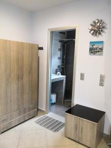 a room with a door to a bathroom with a drawer at Aimilias Family Apartments in Nea Vrasna