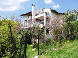 una casa blanca con una valla delante en Guest House Fanny, en Sinemorets