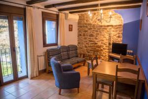 a living room with a table and a dining room at CASA BERNAT in Aren