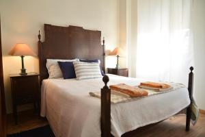 a bedroom with a bed with two hot dogs on it at Blue Castle House in Gouveia