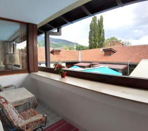 a balcony with a view of a swimming pool at Hostel Pansion Lion in Sarajevo