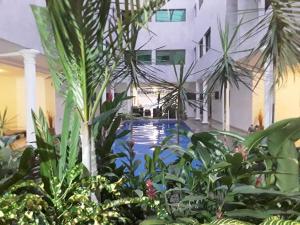 a house with a swimming pool with trees and plants at Residence Clean Apparts in Abidjan