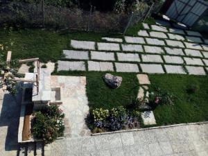 a garden with some flowers and a stone pathway at Casa Del Grey in Balchik