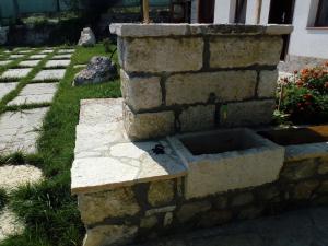 a stone retaining wall with a bird sitting on it at Casa Del Grey in Balchik +36 photos