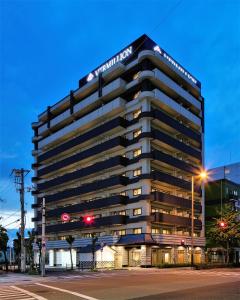 Un edificio alto y negro con un cartel. en Ostay Vermillion Namba en Osaka