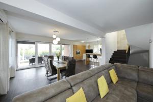 a living room with a couch and a dining room at Villas A & N in Zaton