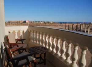 a balcony with chairs and a view of the beach at Safaga house sea view in Hurghada