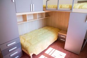 a small bedroom with a bed and shelves at Casa del Grillo in Molfetta