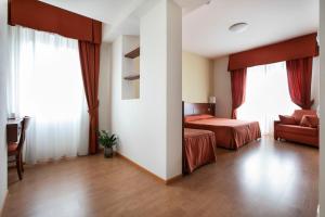 A bed or beds in a room at Hotel Conradi