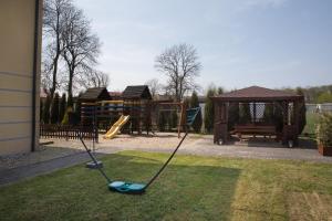 a playground with a swing in the grass at Willa Sarbinowo in Sarbinowo