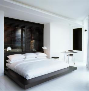 a bedroom with a large bed and a table at Habita Monterrey, a Member of Design Hotels in Monterrey