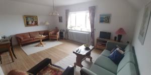 una sala de estar con un sofá y una mesa en My Bureau Apartment, en Korsør
