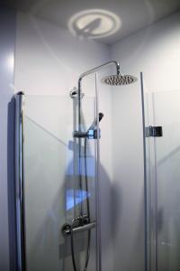 a shower with a glass door in a bathroom at Hotel Wahlmüller in Sattledt