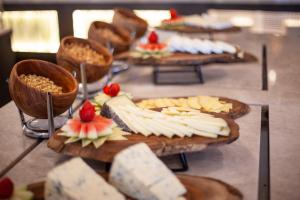 a table with plates of cheese and other foods at Grupotel Parc Natural & Spa in Playa de Muro