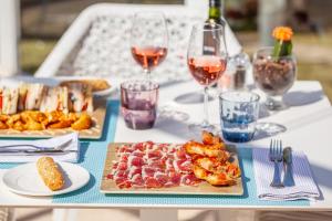 a table with plates of food and glasses of wine at Grupotel Parc Natural & Spa in Playa de Muro