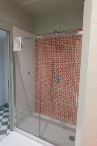 a shower with a glass door in a bathroom at Hotel Baia Di Puolo in Massa Lubrense