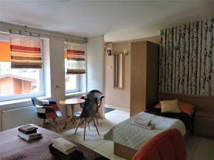 a bedroom with a bed and a table and chairs at FALA na WYSPIE in Sobieszewo +109 photos