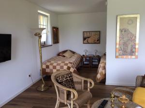 a room with two beds and a table and chairs at Wollmeiner's Lodge in Arnsberg