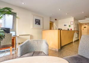 an office with two chairs and a table and a desk at Holyrood Aparthotel in Edinburgh