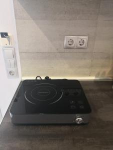 a black stove sitting on the floor in a kitchen at Aimilias Family Apartments in Nea Vrasna