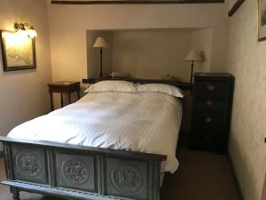 a bedroom with a large bed and a dresser at The Kilverts Inn in Hay-on-Wye