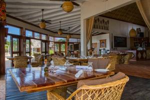 a dining room with a large wooden table and chairs at The Colonial at Jaguar Reef in Hopkins