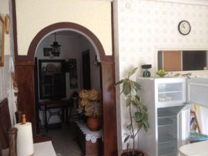 a kitchen with an archway leading into a room with a table at MRZ Rentals San Martín de Luiña in San Martín de Luiña
