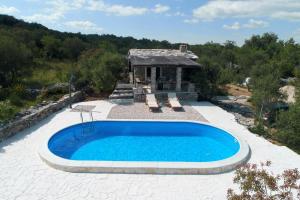 a swimming pool in the middle of a patio at Holiday Home Petar in Drage +19 photos