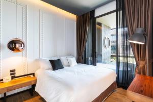 a bedroom with a bed and a desk and a window at Lucky Holidays in Saturdays Residence in Rawai Beach +30 photos