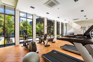 an indoor gym with treadmills and elliptical machines at Lucky Holidays in Saturdays Residence in Rawai Beach
