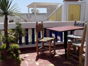 a table and chairs sitting on a balcony at Dar El Paco in Essaouira