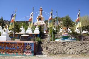 a temple with flags and stairs in front of it at Hotel Los Nogales in Campo