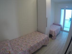 a bedroom with a bed and a chair in it at New Alfieri - Agenzia Cocal in Caorle
