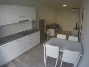 a kitchen and living room with a table and chairs at New Alfieri - Agenzia Cocal in Caorle
