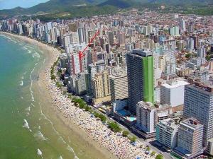 an aerial view of a city with a beach and buildings at APARTAMENTO VISTA MAR - Pé na areia in Balneário Camboriú