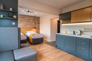 a room with a bed and a kitchen with a couch at B&P studios in Varna City