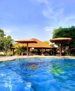 a swimming pool in front of a resort at Pousada do Lajes in Carolina