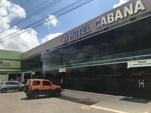 an orange truck parked in front of a building at Hotel Cabana in Teresina