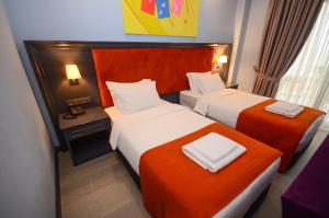 Postel nebo postele na pokoji v ubytování Batumi Palm Hotel