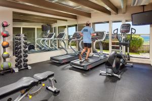a man standing on a treadmill in a gym at Cavalier Oceanfront Resort in San Simeon