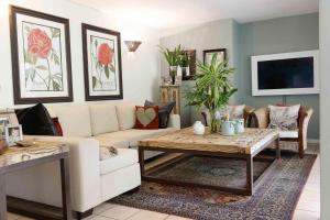 a living room with a couch and a table at Villa Gardenia One Bedroom in Ballito
