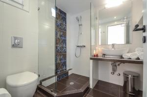 La salle de bains est pourvue de toilettes, d'un lavabo et d'un miroir. dans l'établissement Sun Beach Hotel, à Naxos Chora
