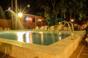 a swimming pool at night with a slide in it at Casa Hotel Guaracú in Santa Fe de Antioquia