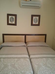 two beds sitting next to each other in a bedroom at Torremolinos Beach Apartment in Torremolinos