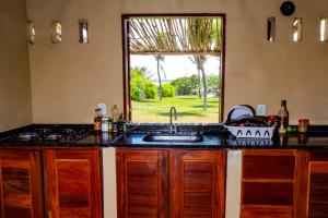 a kitchen with a sink and a window at Beach House- KiteAliCori in Ponta do Anel