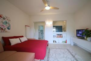 a living room with a red bed and a couch at La Casa di Eva in Vittorio Veneto